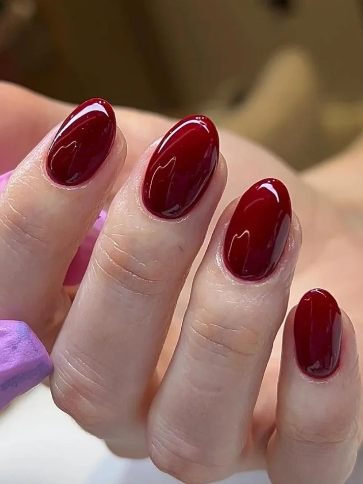 Close-up of dark red BIAB manicure