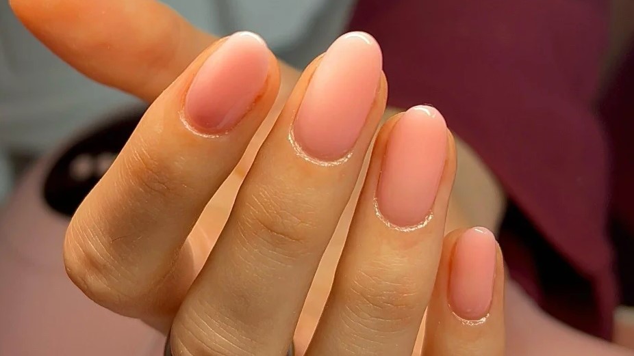 Close-up of sheer pink BIAB manicure